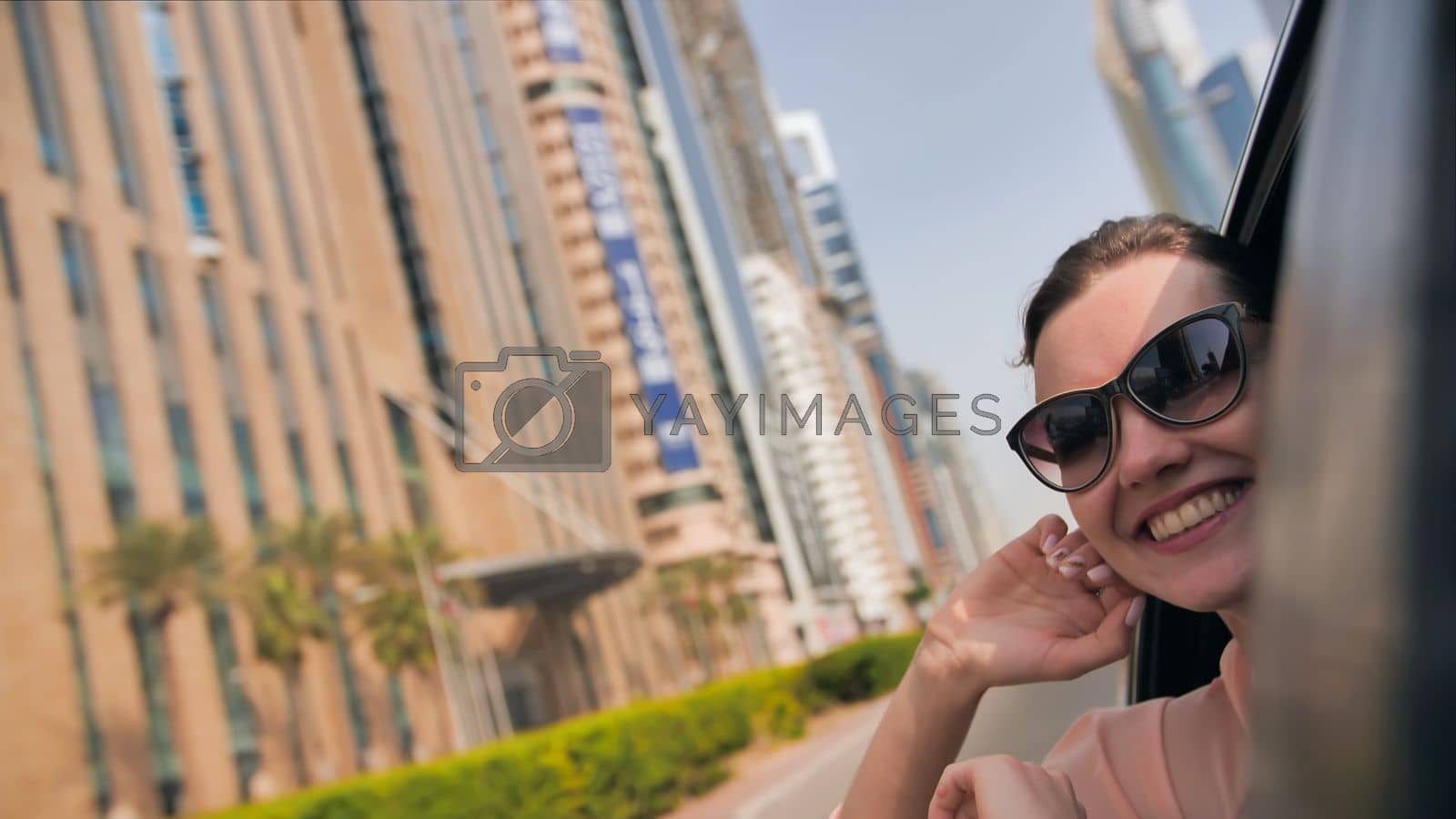 Royalty free image of Happy Girl driving a car in Dubai. UAE. by DovidPro