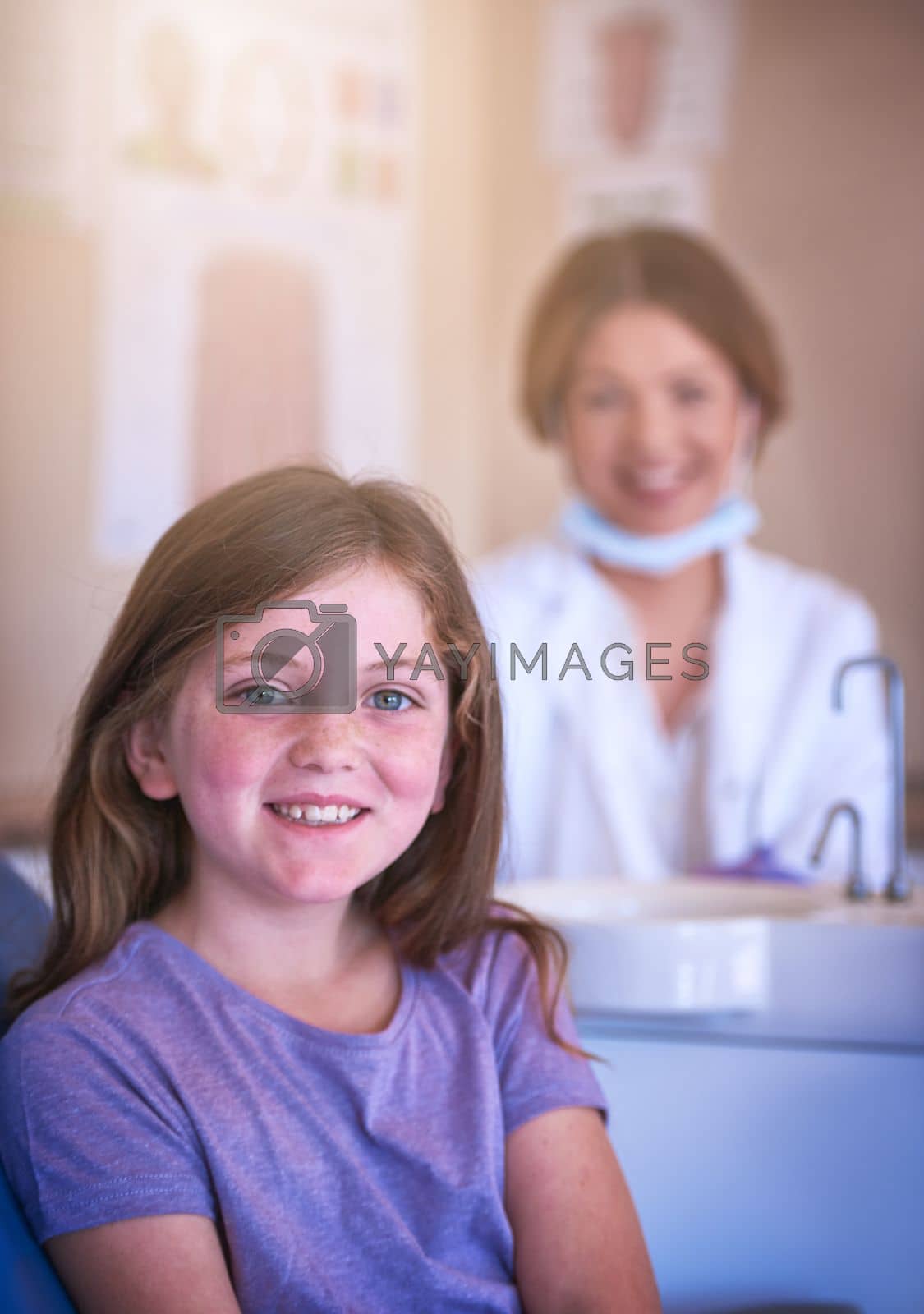 Royalty free image of I enjoy my dentist visits, I dont need bribery. a little girl at the dentist for a checkup. by YuriArcurs