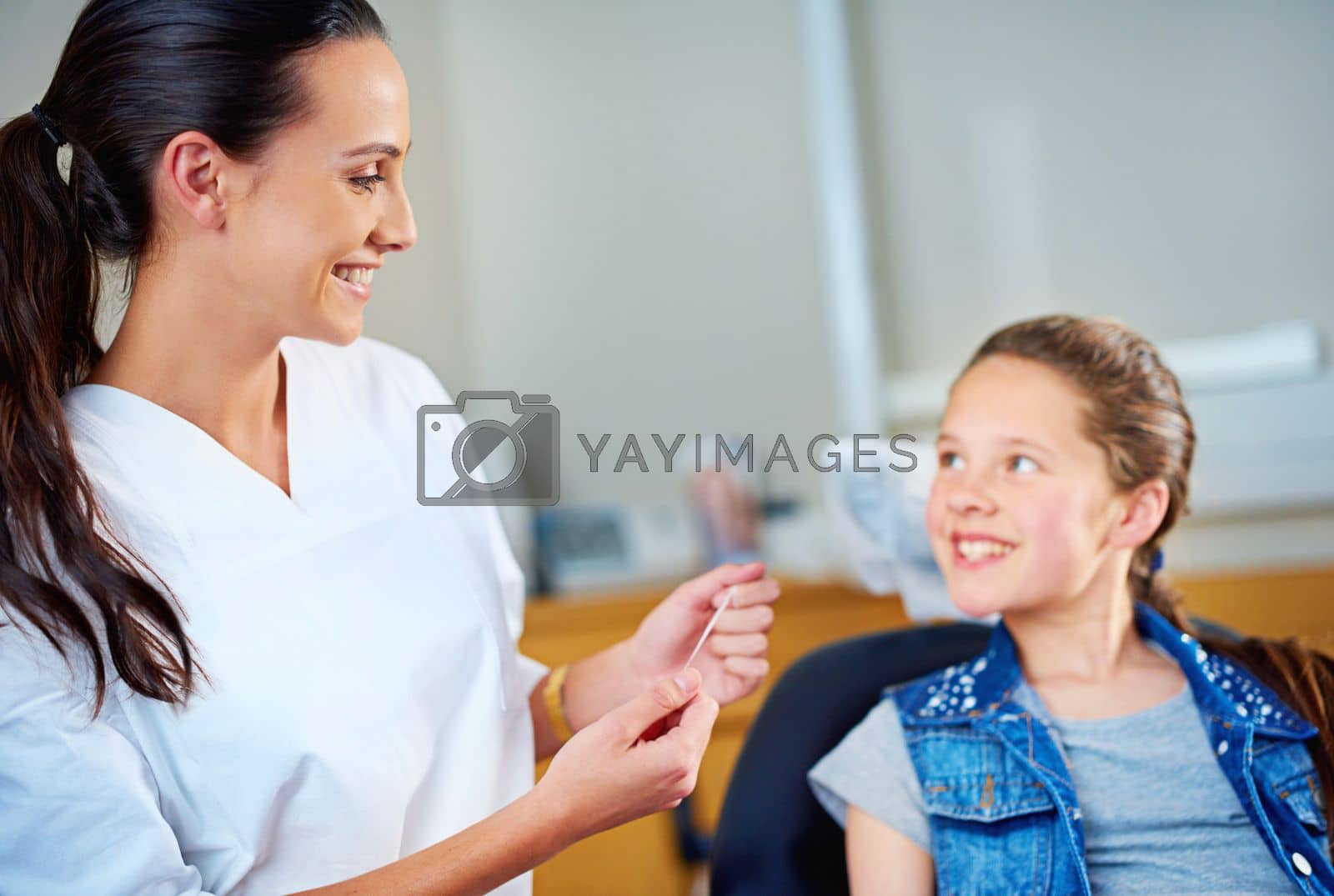 Royalty free image of Have you been brushing. a female dentist and child in a dentist office. by YuriArcurs