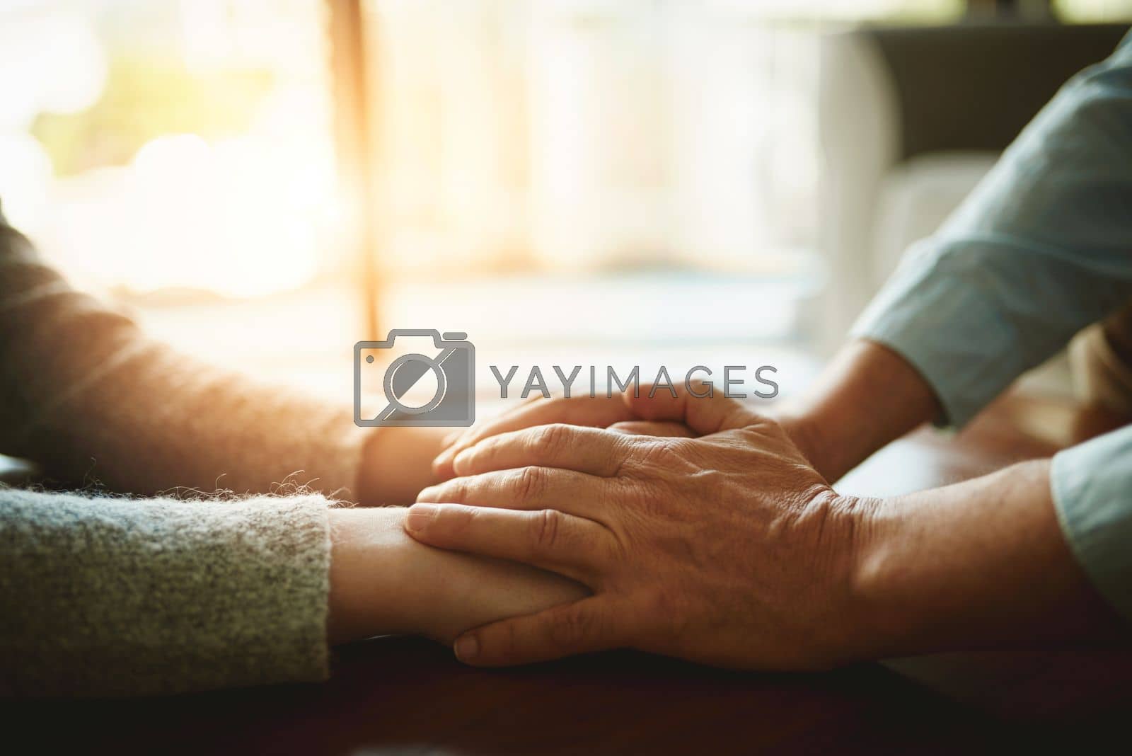 Royalty free image of Compassion is one of lifes greatest values. Closeup shot of two unidentifiable people holding hands in comfort. by YuriArcurs
