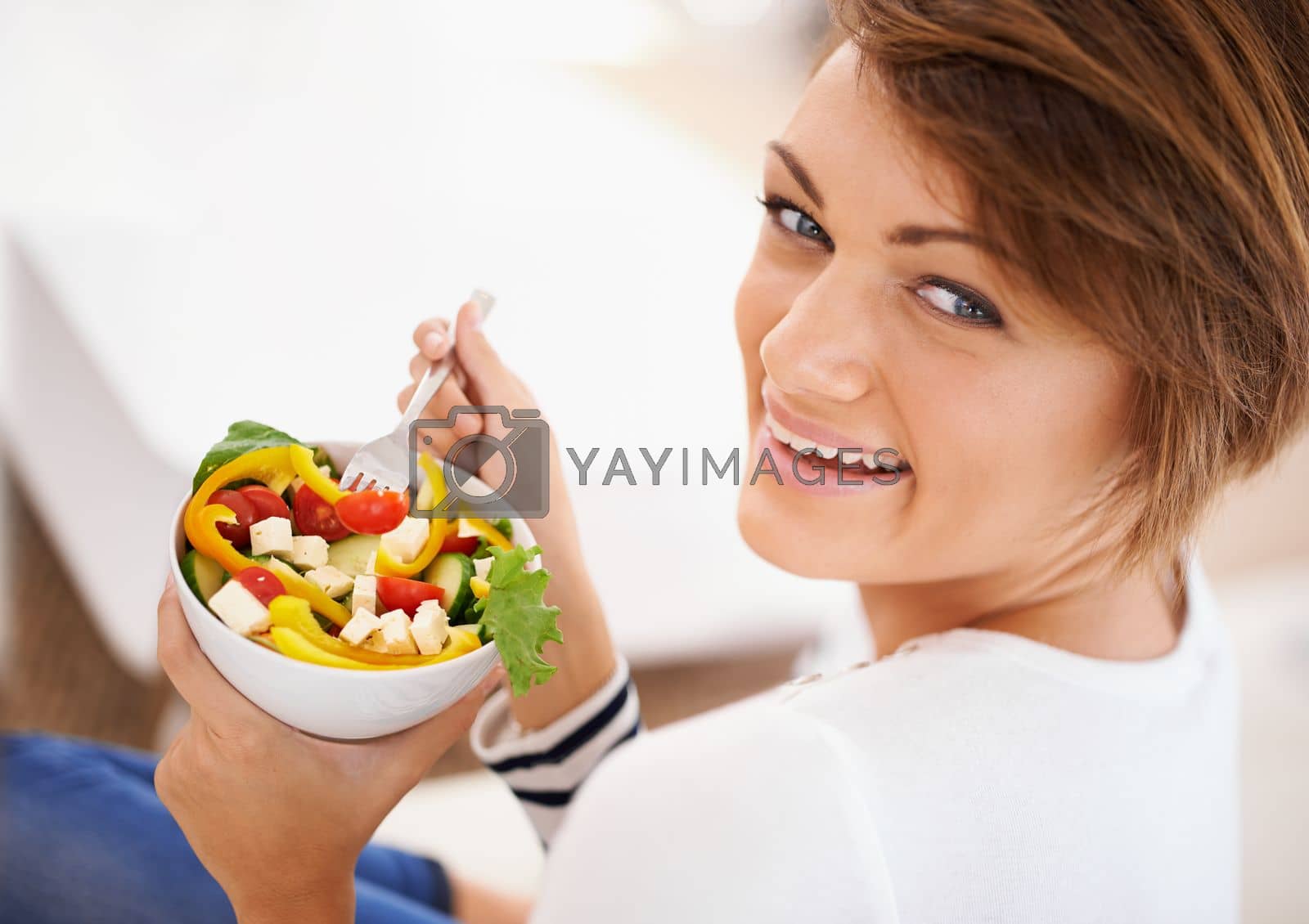 Royalty free image of Healthy eating is her best beauty treatment. an attractive young woman eating a salad. by YuriArcurs
