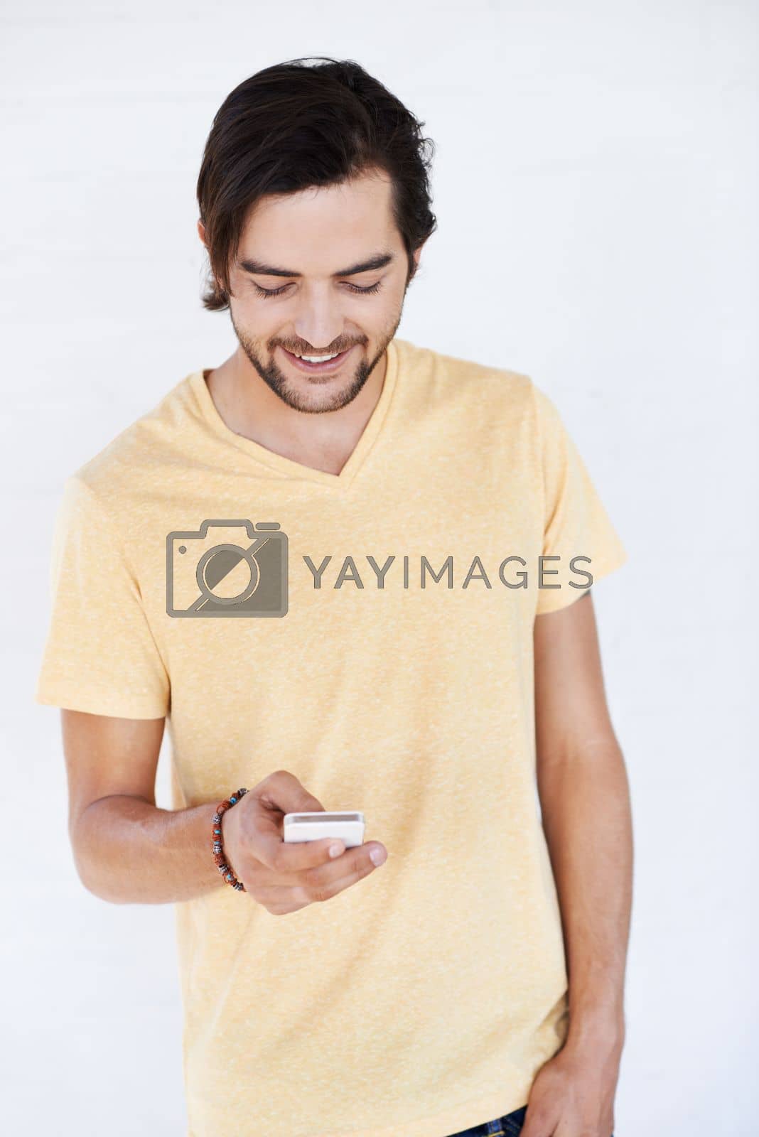 Royalty free image of Phone, communication and man on technology typing a cellphone text with isolated white background. Mobile conversation, model and smile of a person with a mobile phone texting with technology by YuriArcurs