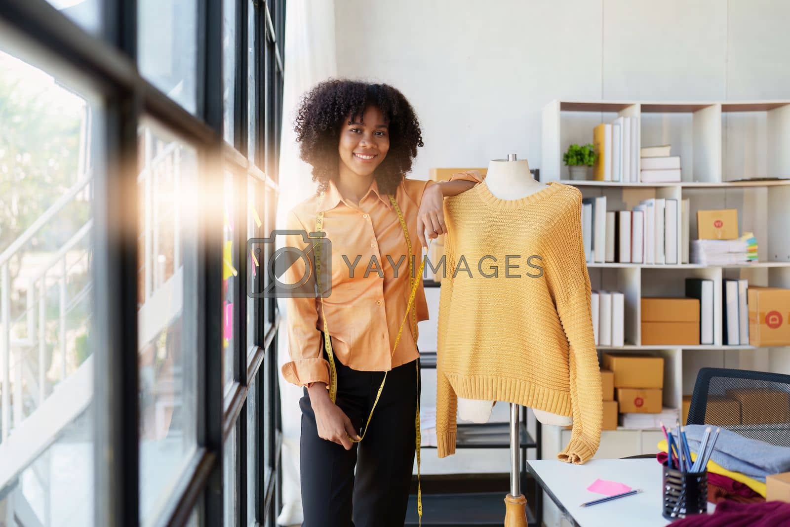 Royalty free image of Portrait of young african american woman fashion designer stylish working at fashion studio by itchaznong