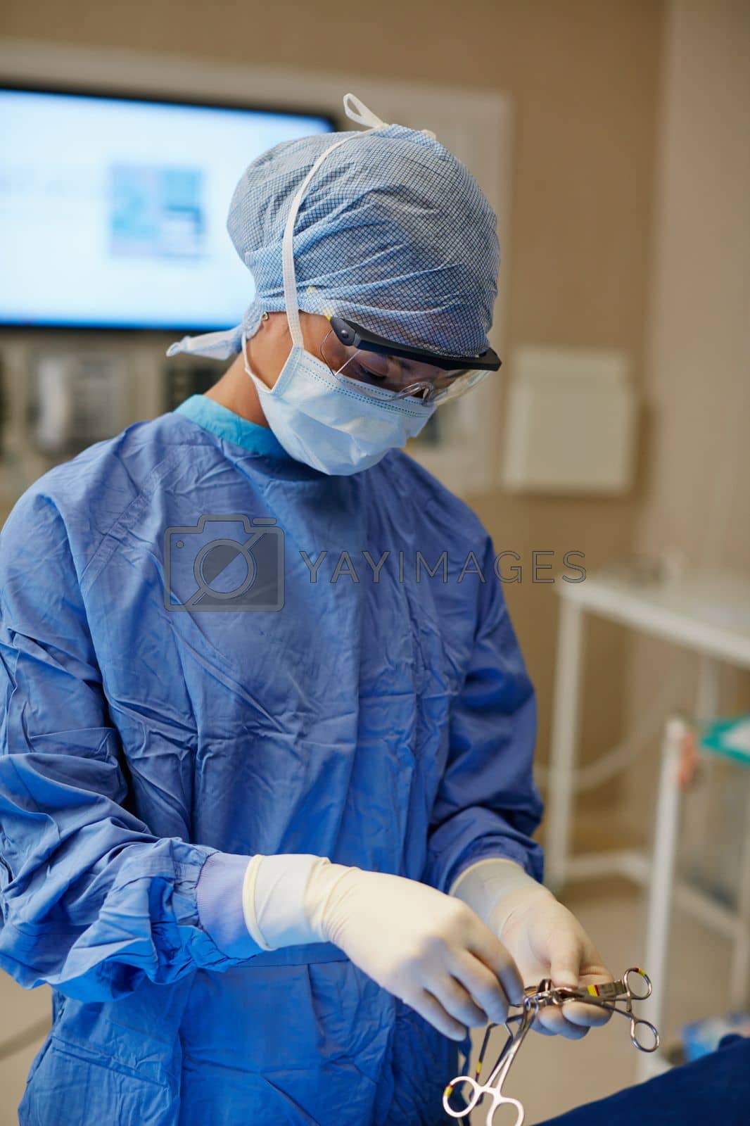 Royalty free image of Shes a gifted young surgeon. a surgeon preparing her tools for a surgical operation. by YuriArcurs