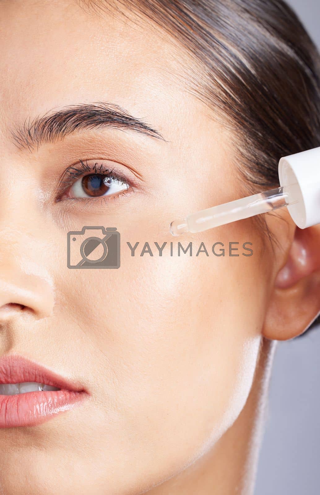 Royalty free image of Beauty, face skincare and woman with serum for glowing skin hydration, anti aging healthcare or facial protection. Relax aesthetic girl with liquid spa product, collagen oil or hyaluronic acid by YuriArcurs