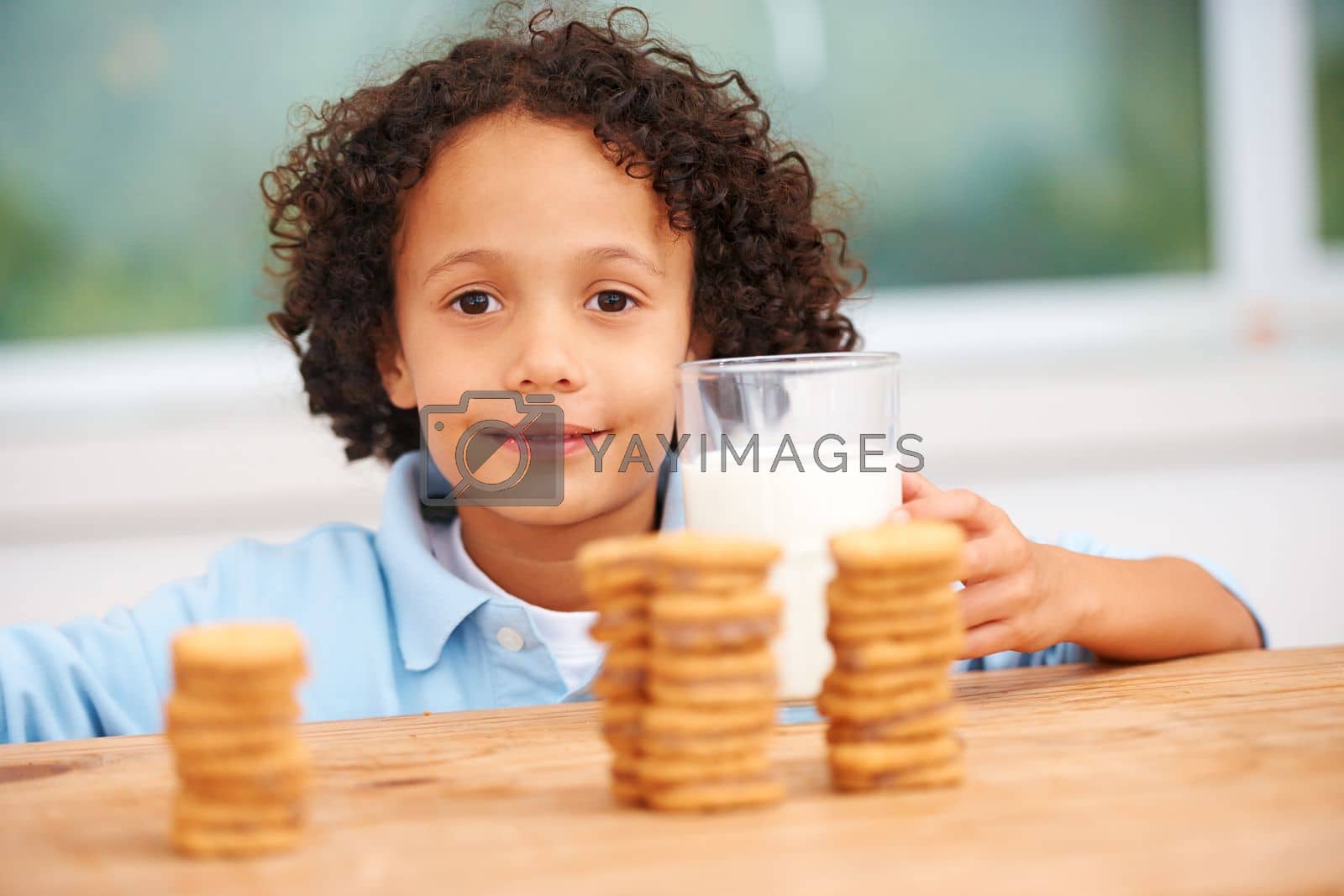 Royalty free image of Mmm, so many cookies just for me. A cute young boy grabbing a cookie from the cookie jar. by YuriArcurs