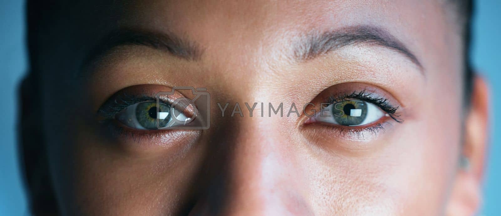 Royalty free image of Woman, face and eyes looking for biometrics, optics or vision in the future for scanning identity. Closeup of female eye in focus for scan, cyber security or facial recognition with optical iris by YuriArcurs