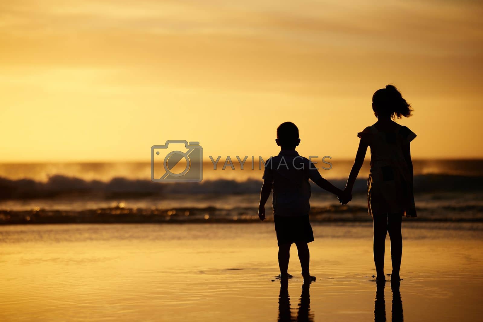 Royalty free image of Staring into blackness of distant stars. an adorable brother and sister bonding at the beach. by YuriArcurs