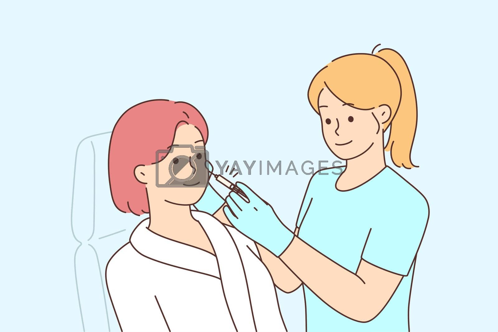 Royalty free image of Woman client get face procedures in beauty salon by Vasilyeu