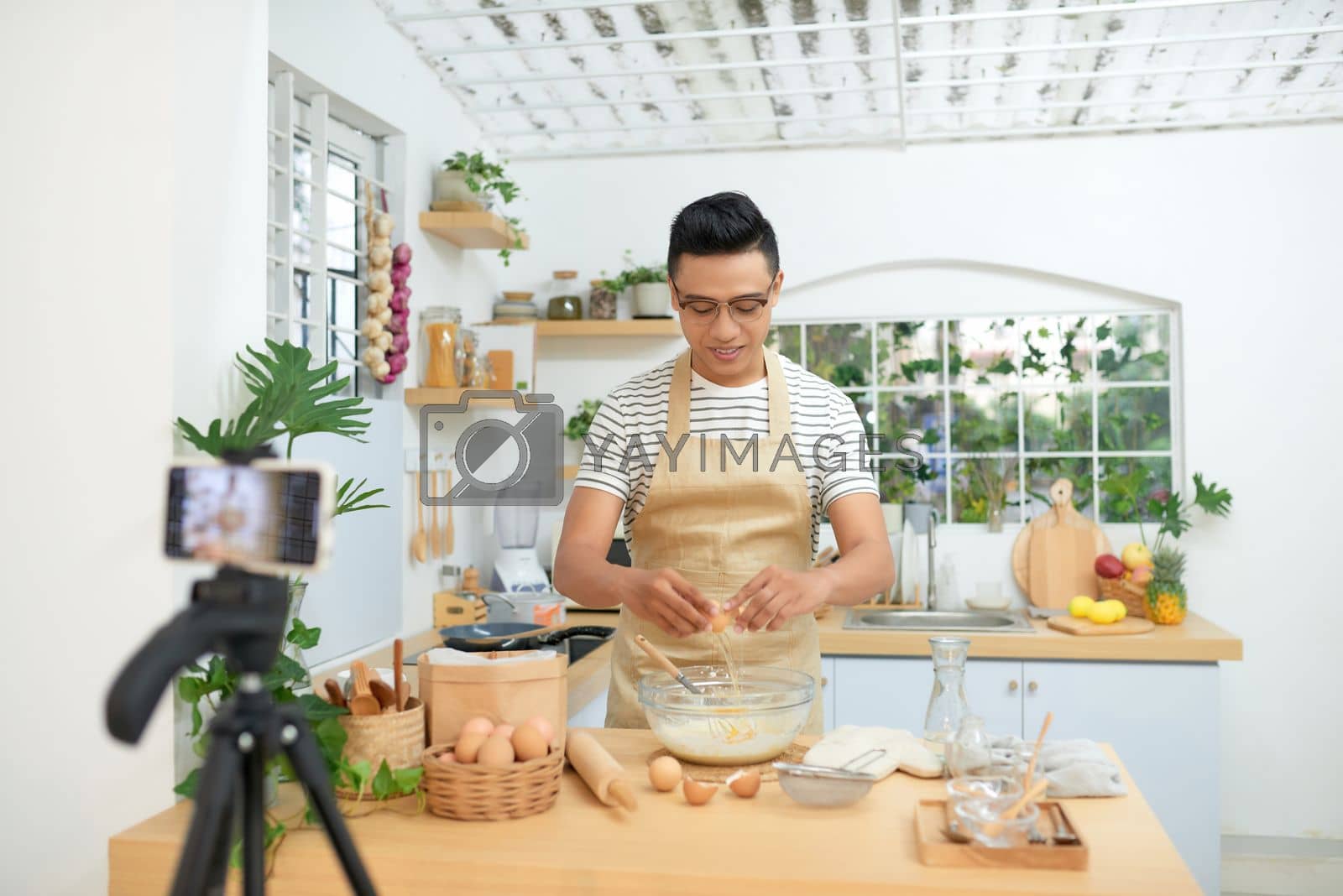 Royalty free image of Food blogger recording video in his workplace by makidotvn