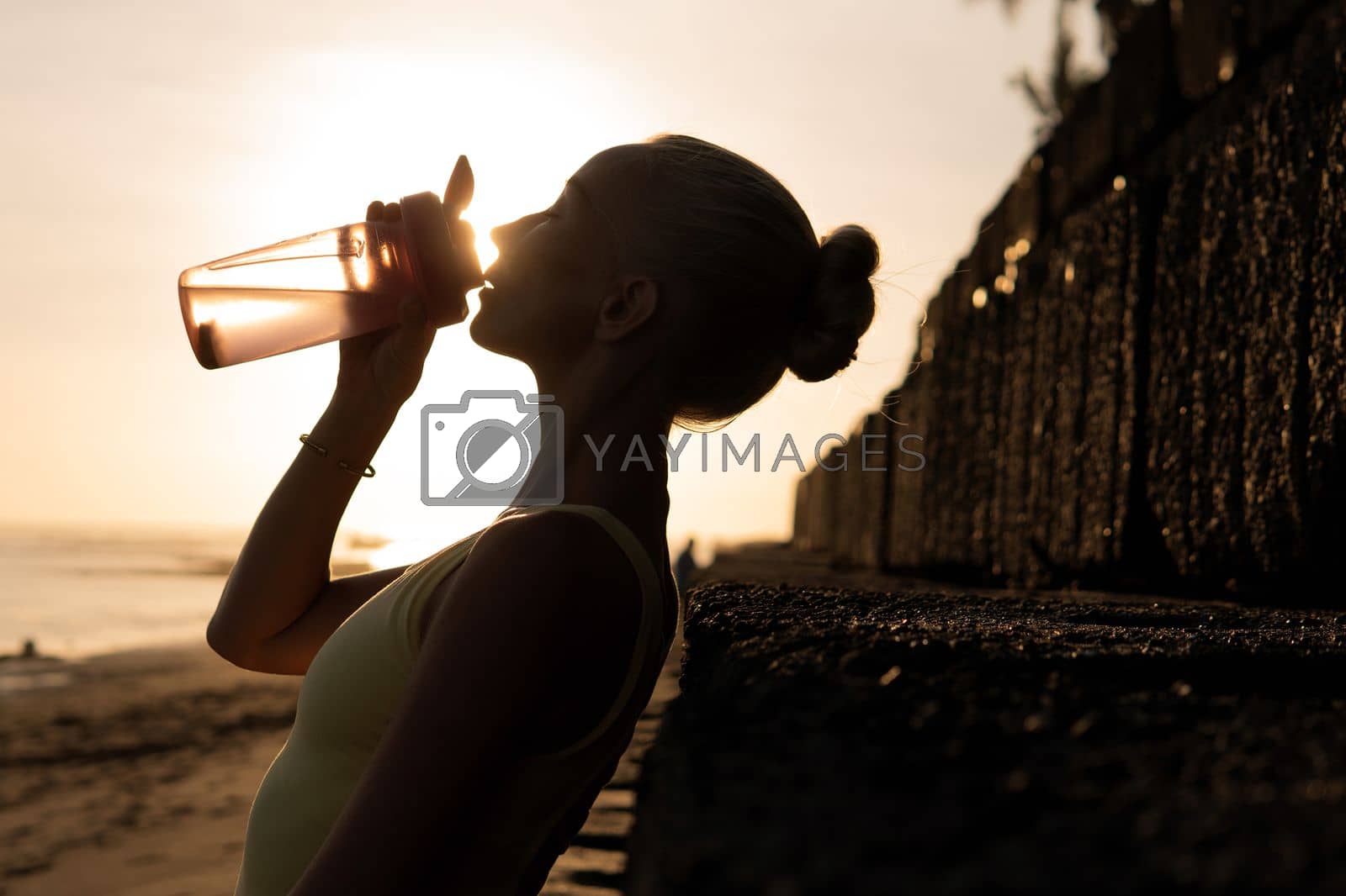 Royalty free image of beautiful woman drinking water by Alexzhilkin