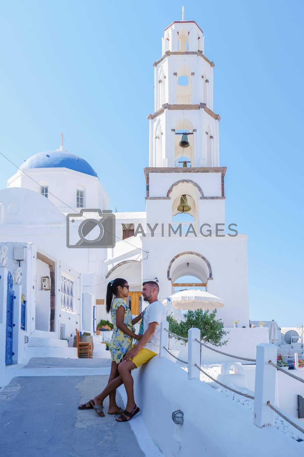 Royalty free image of Couple hugging and kissing on a romantic vacation in Santorini Greece, men and women visit Santorini by fokkebok