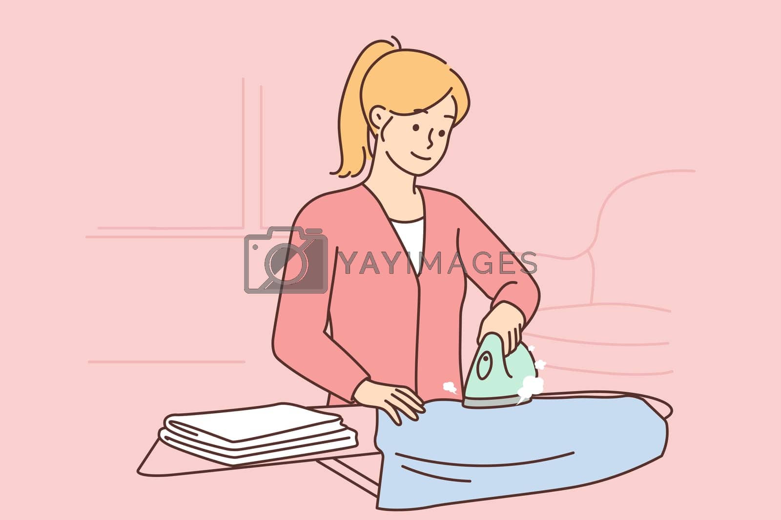 Royalty free image of Woman ironing clothes on an ironing board by Vasilyeu