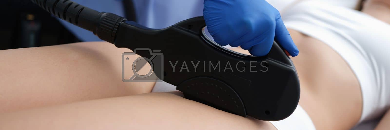 Royalty free image of Beautician removes hair in bikini area with laser by kuprevich