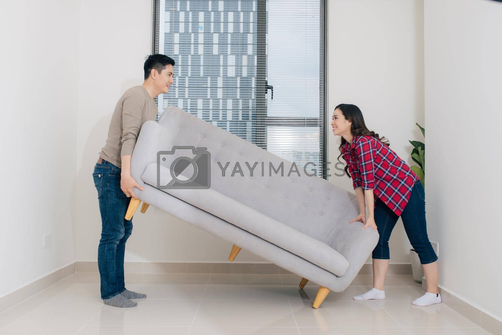 Royalty free image of Just married couple of young man and woman feeling unbelievable chilling in their new house by makidotvn