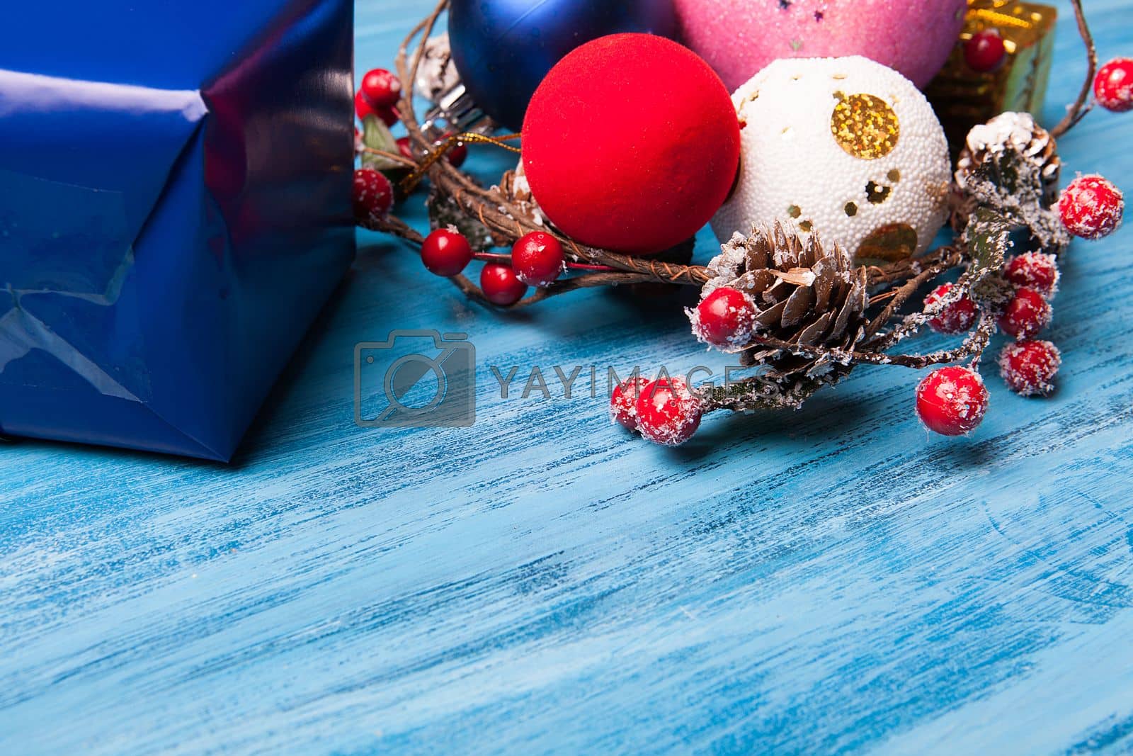 Royalty free image of Over head view of christmas gift and decoration over blue wooden by DCStudio