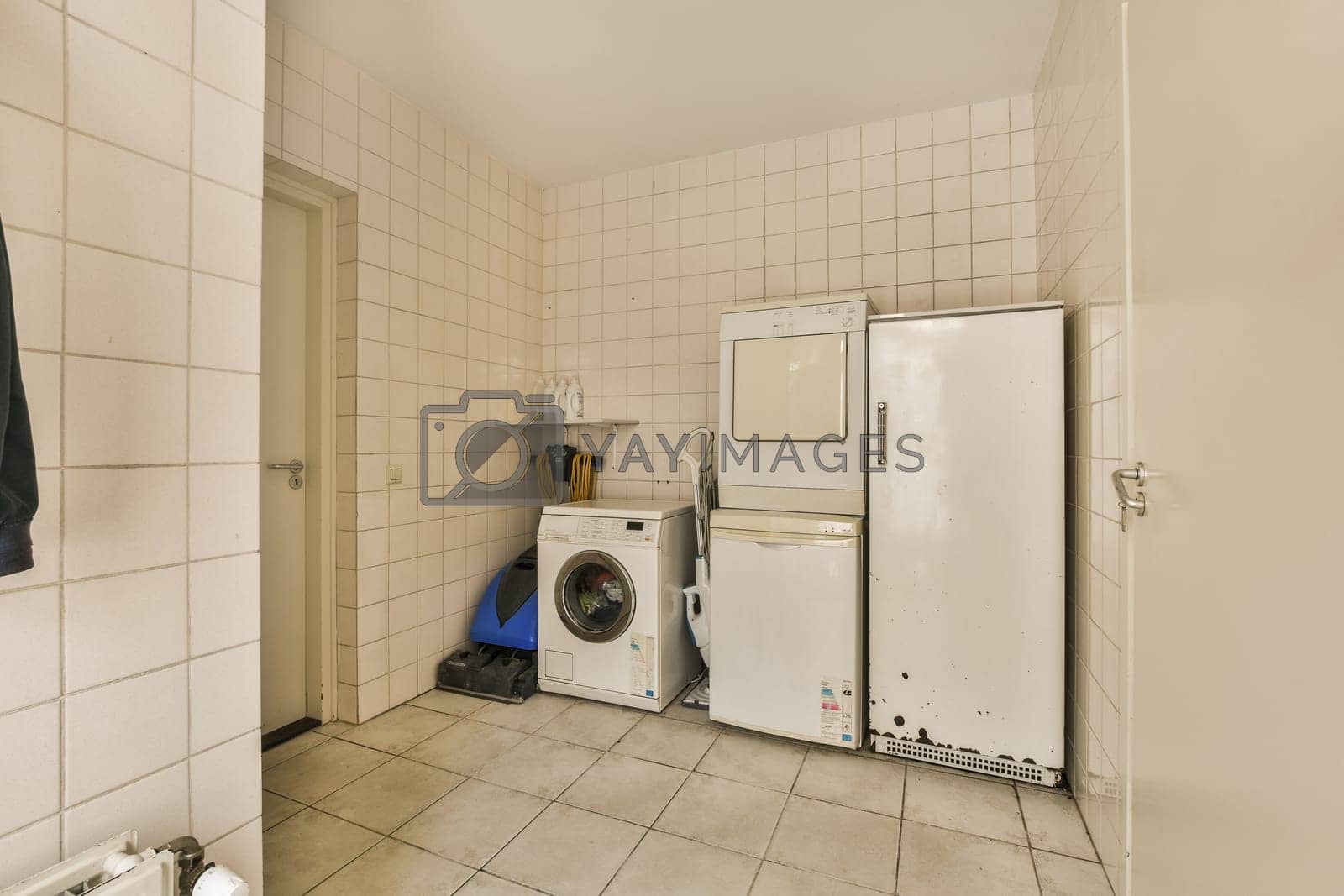 Royalty free image of a kitchen with a washing machine and a refrigerator by casamedia