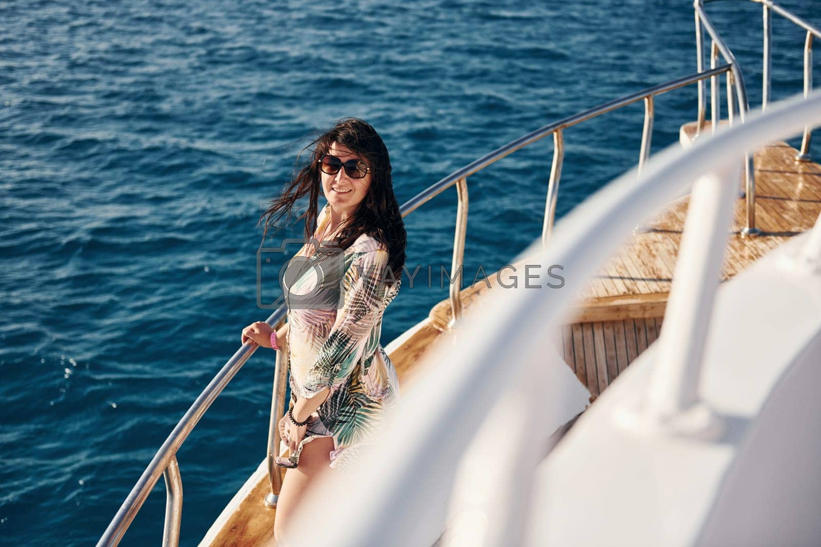 Royalty free image of Mature woman standing on the yacht and enjoying her vacation on the sea by Standret
