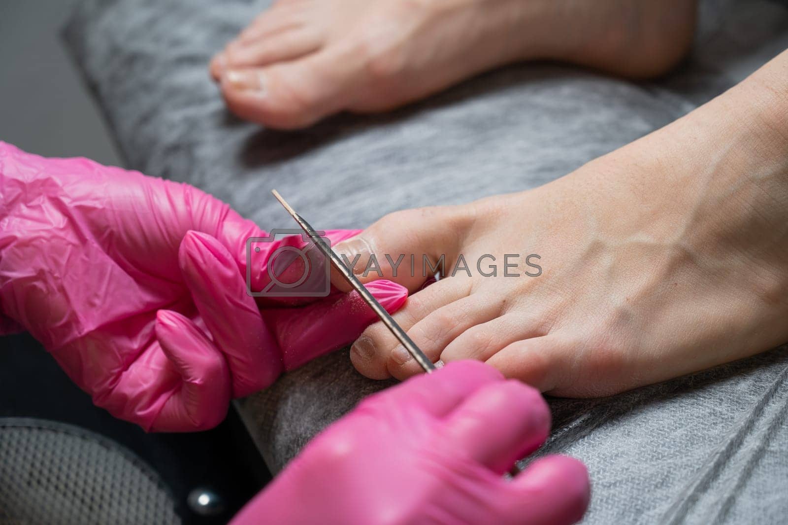 Royalty free image of The master makes hardware pedicures to the client. by mrwed54