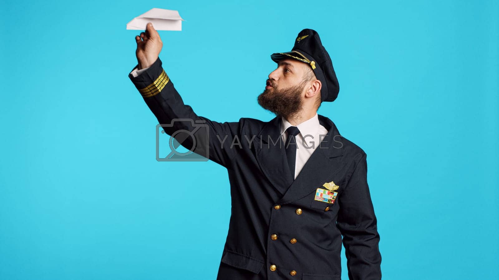 Royalty free image of Young man working as pilot building paper plane by DCStudio