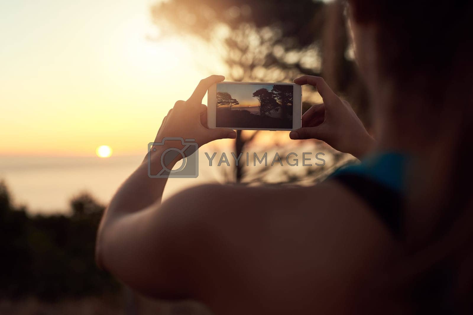 Royalty free image of Capture the beauty mother nature has to offer. an unrecognizable woman taking photos with her cellphone. by YuriArcurs