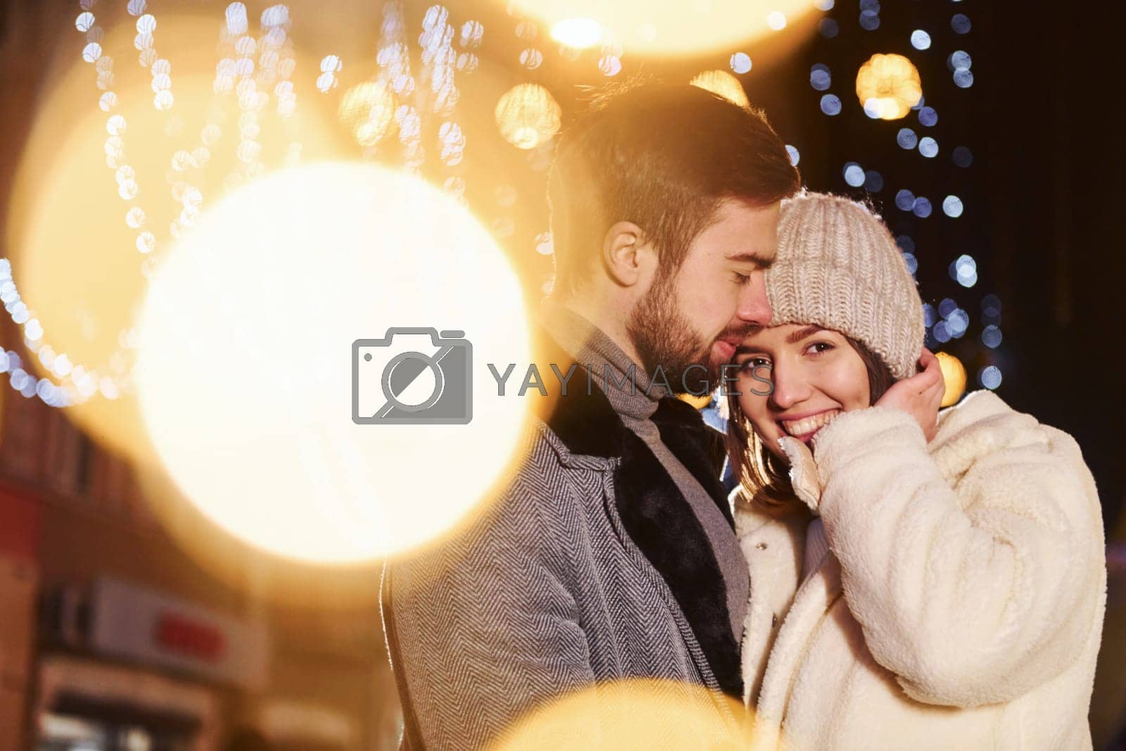 Royalty free image of Closeness of the people. Happy young couple celebrating New year outdoors on the street by Standret