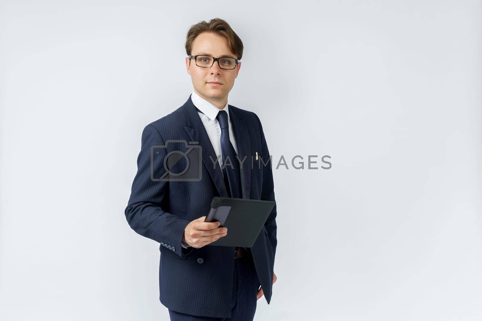 Royalty free image of Portrait of a businessman in a blue suit holding an electronic tablet on a white background. by Sd28DimoN_1976