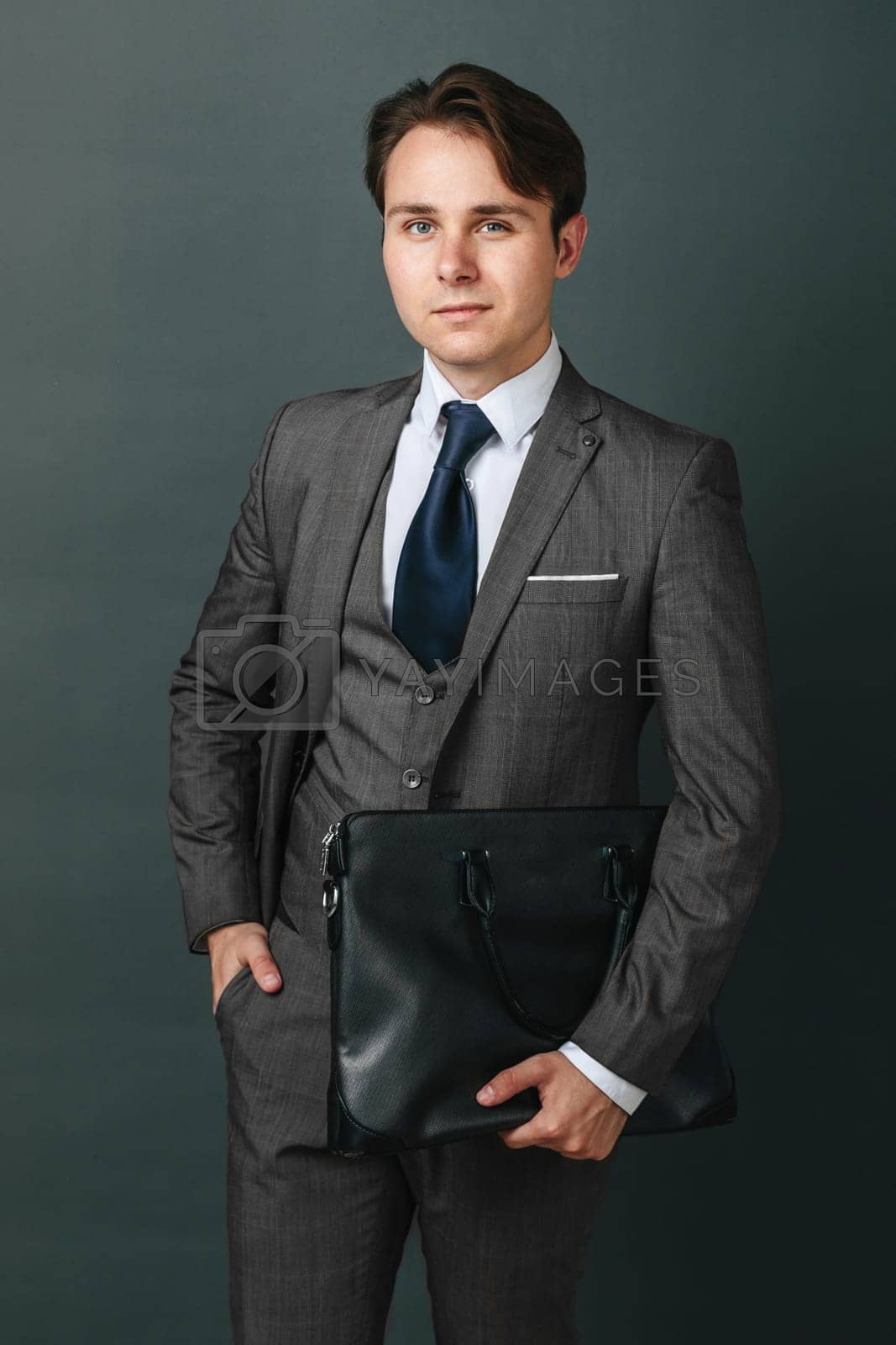 Royalty free image of Portrait of a businessman who is holding a briefcase. Light background by Sd28DimoN_1976
