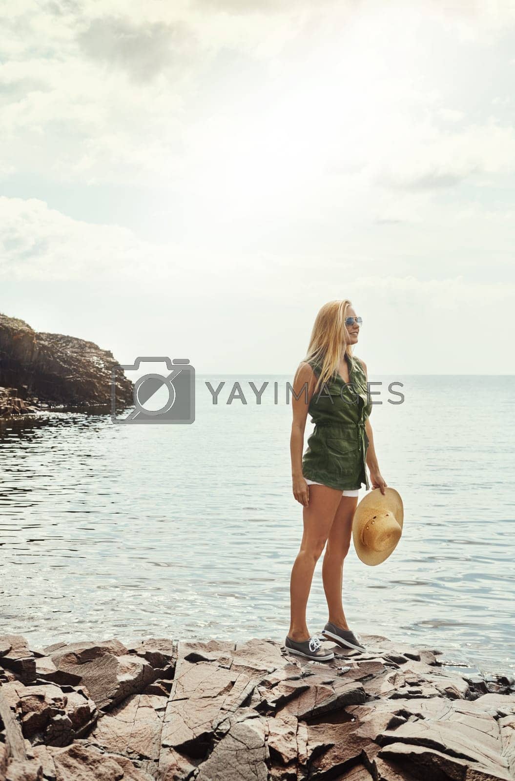 Royalty free image of The beauty of nature is simply breathtaking. an attractive young woman spending a day at the lake. by YuriArcurs