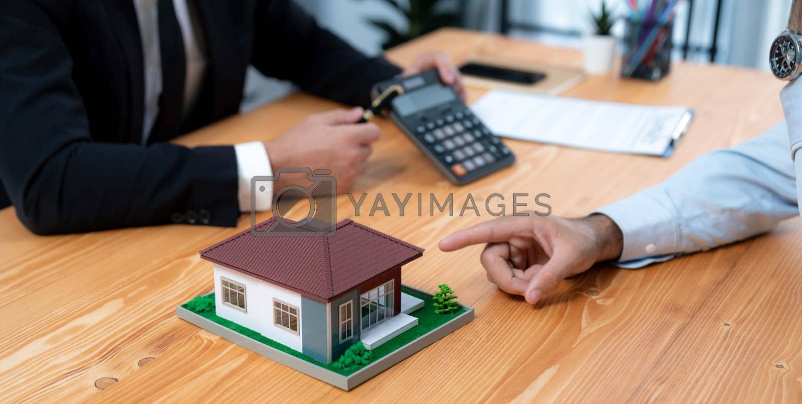 Royalty free image of Real estate agent calculate tax and interest discuss with buyer. Fervent by biancoblue