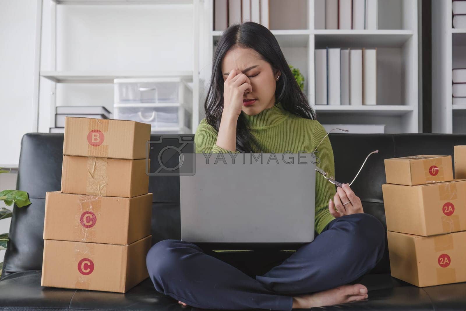 Royalty free image of Asian woman think hard serious working laptop computer at home selling online start up small business owner, e-commerce ideas concept. by wichayada