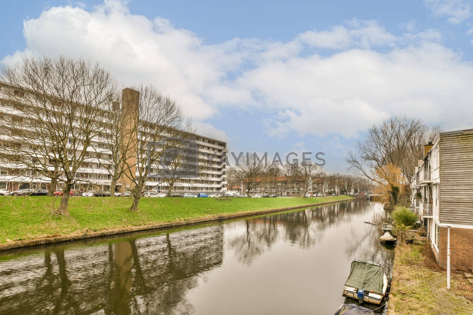 Royalty free image of a canal with houses and a building on the side by casamedia