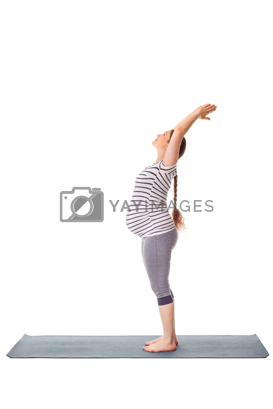 Royalty free image of Pregnant woman doing yoga asana Tadasana Mountain pose by dimol