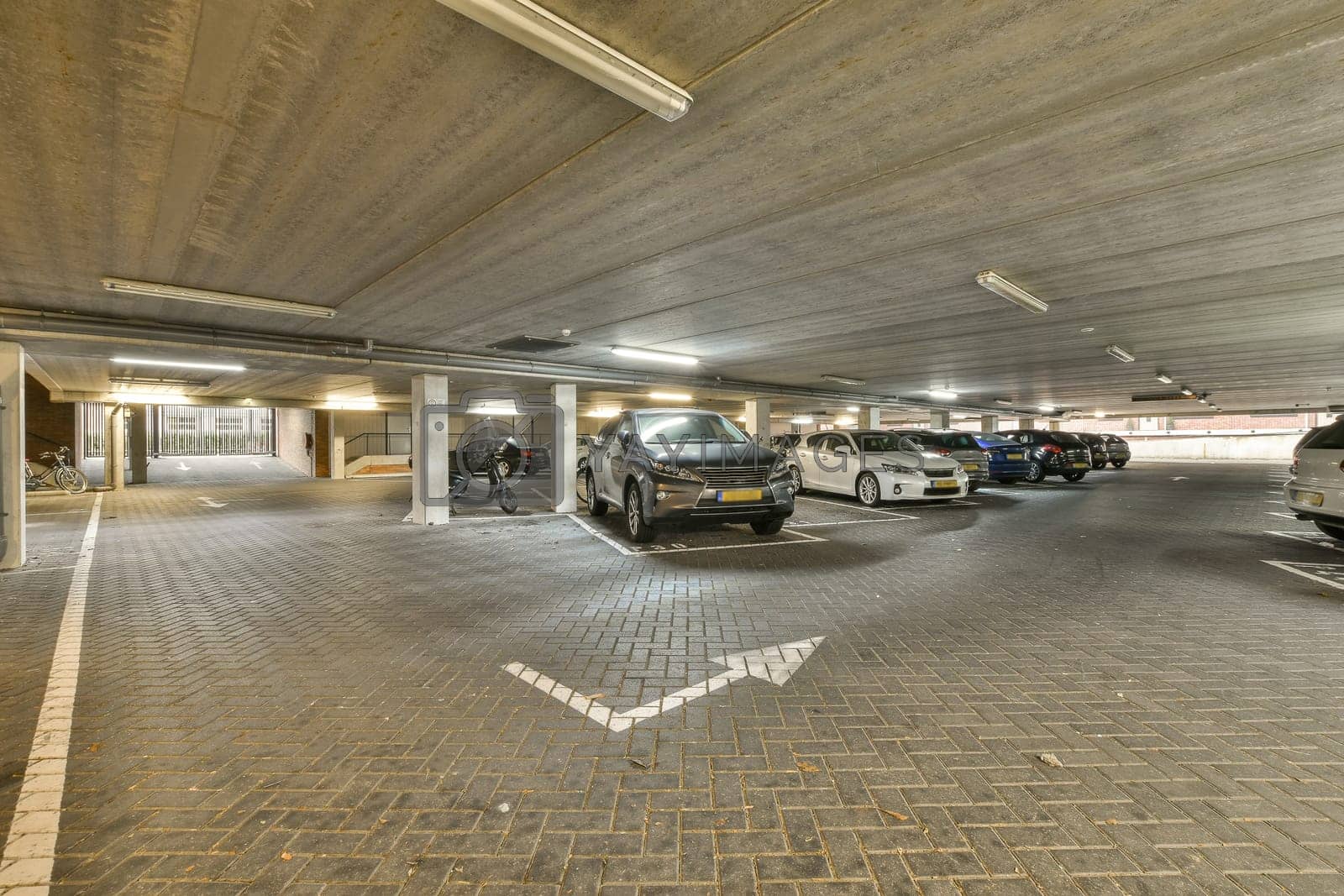 Royalty free image of the parking garage is filled with parked cars by casamedia