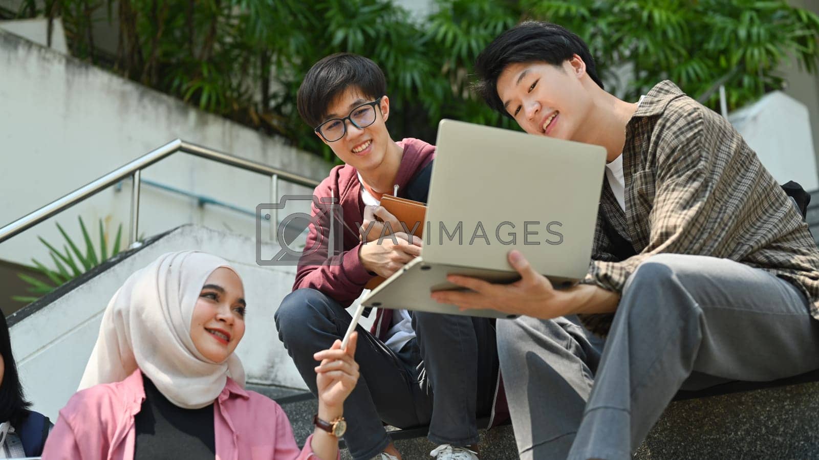 Royalty free image of Group of students are working on academic project or preparing for exam together. Education, Learning and technology concept by prathanchorruangsak