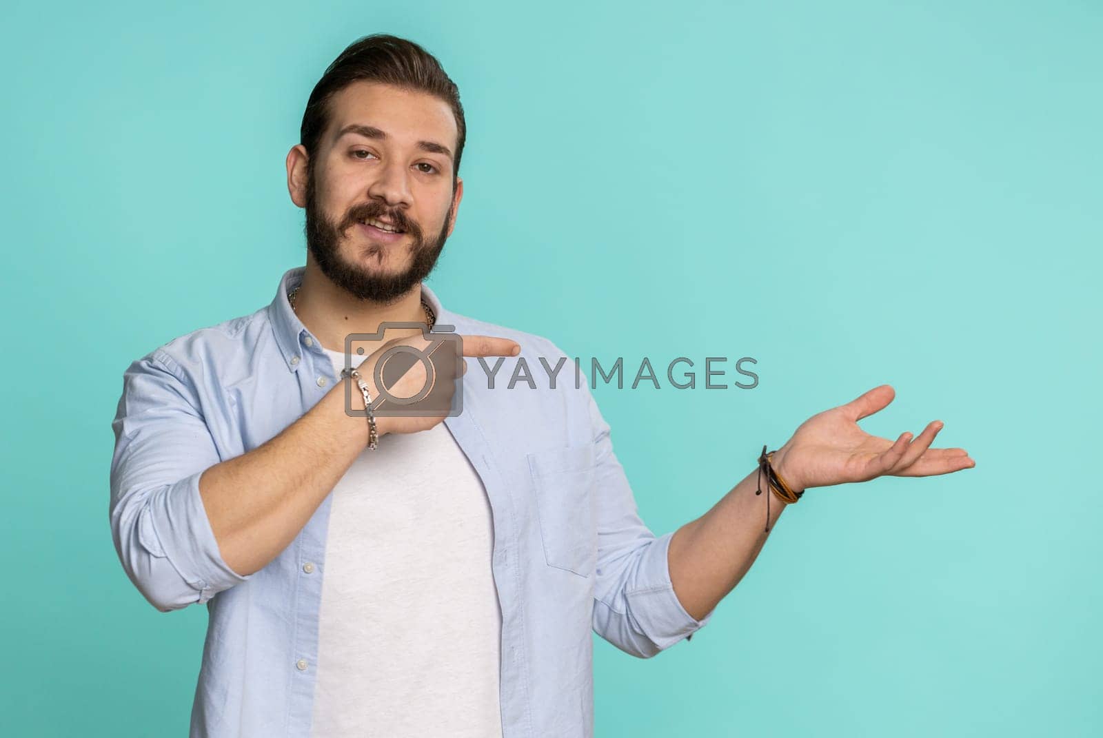 Royalty free image of Lebanese man showing thumbs up pointing empty place, advertising area for commercial text copy space by efuror