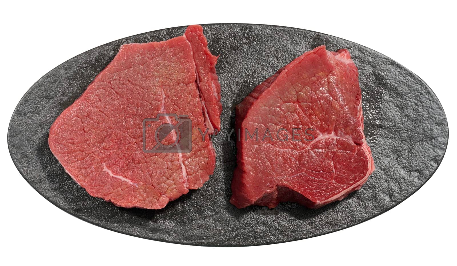 Royalty free image of Round raw beef steak on a white isolated background by ndanko