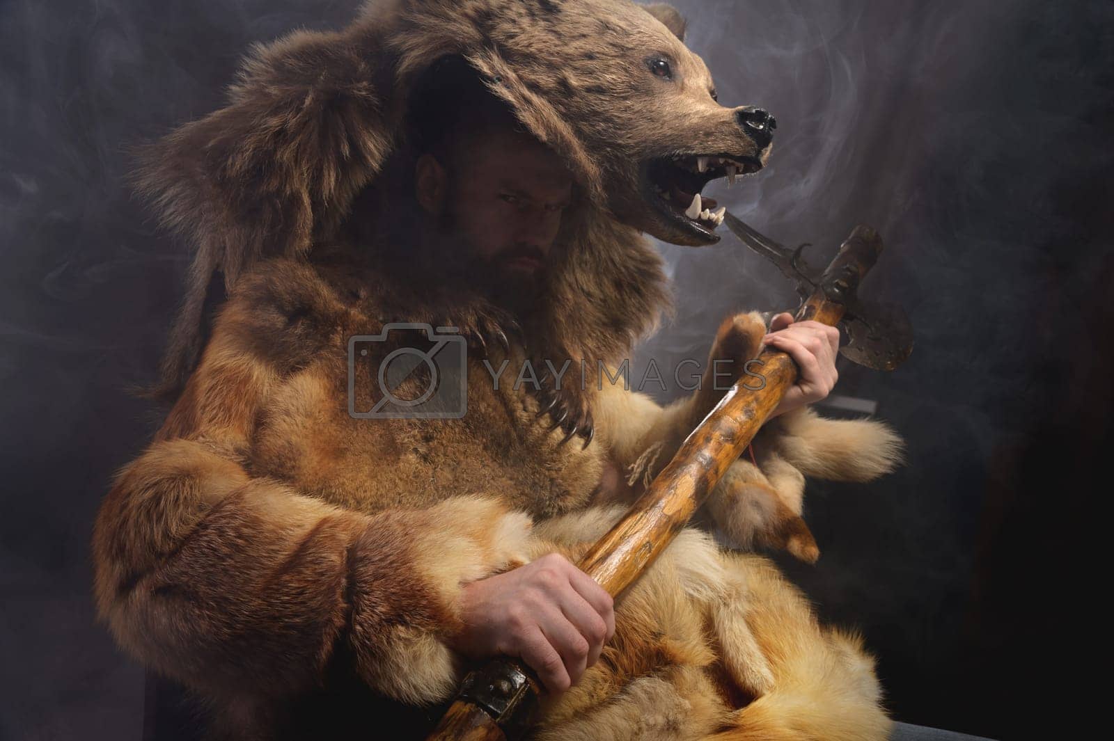 Royalty free image of man with a bear's head, clothes made from the skin of an animal. Warrior cosplay costume by yanik88