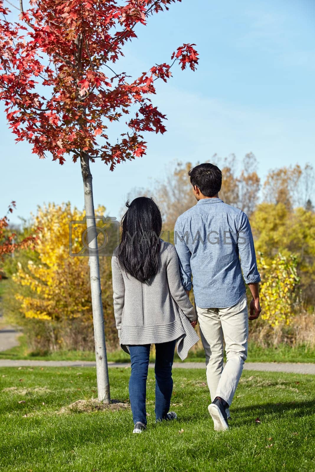 Royalty free image of Fall in love with the beauty nature has to offer. a loving young couple out for a walk in the park. by YuriArcurs