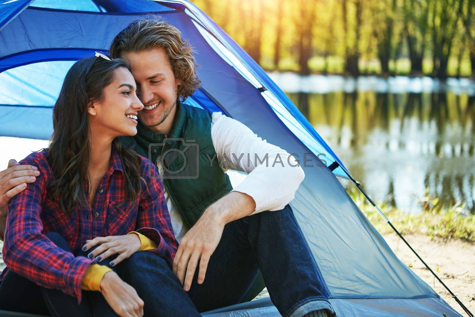Royalty free image of Transform your camping into a romantic getaway. an adventurous couple out camping together. by YuriArcurs