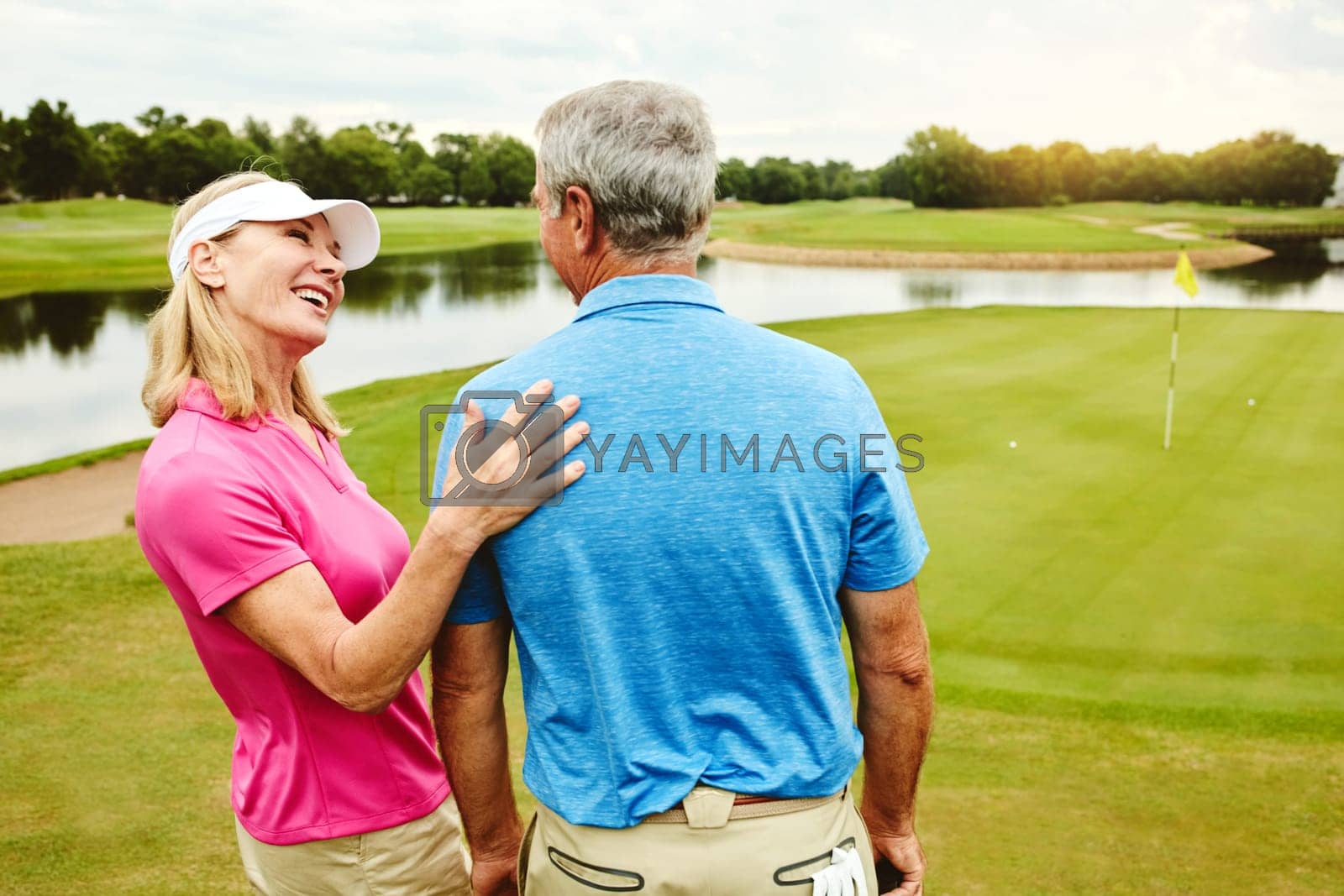 Royalty free image of Spending the whole day attached at the hip. a mature couple out playing golf together. by YuriArcurs