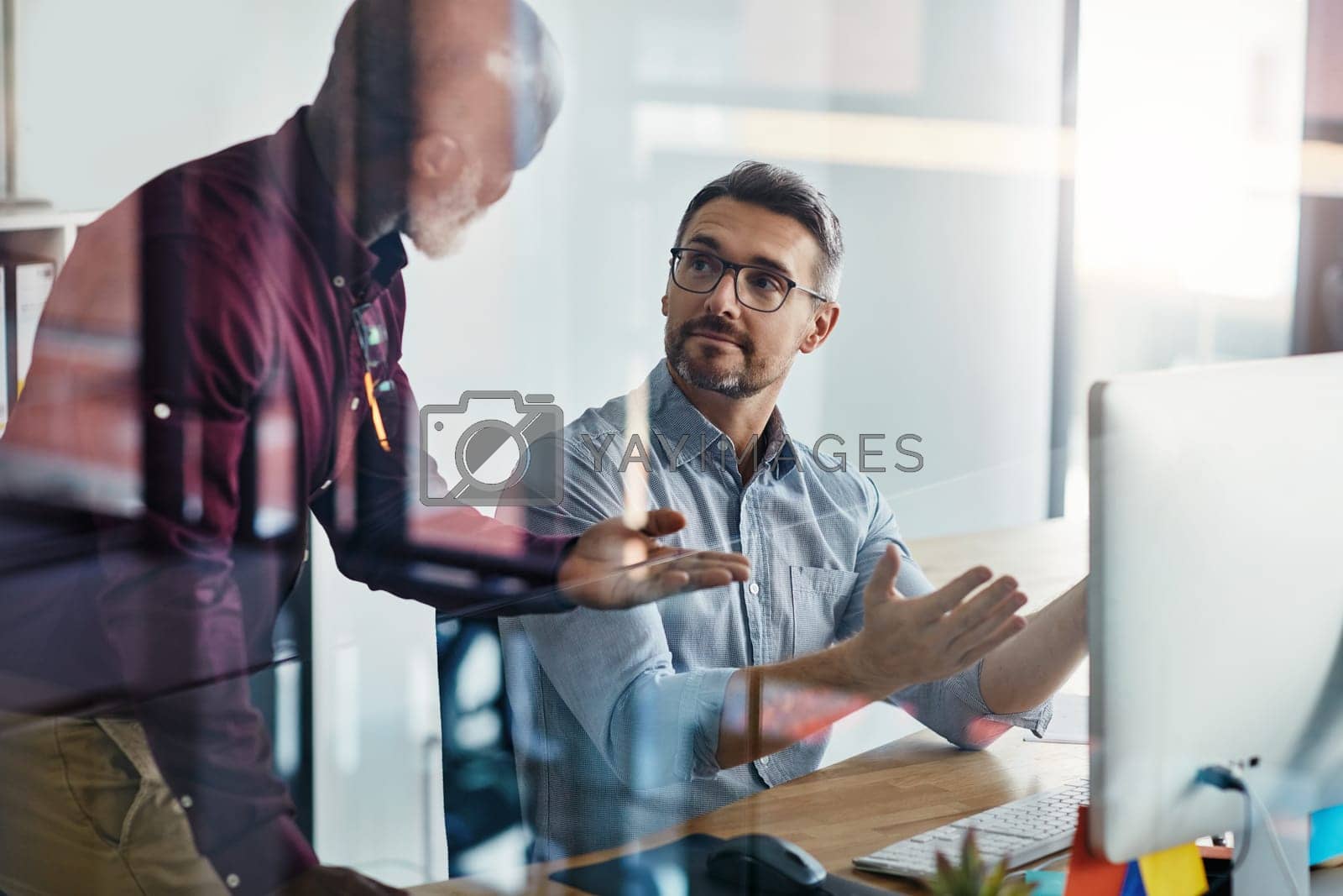 Royalty free image of We need people to push us to greater accomplishments. two businesspeople working on a computer in an office. by YuriArcurs