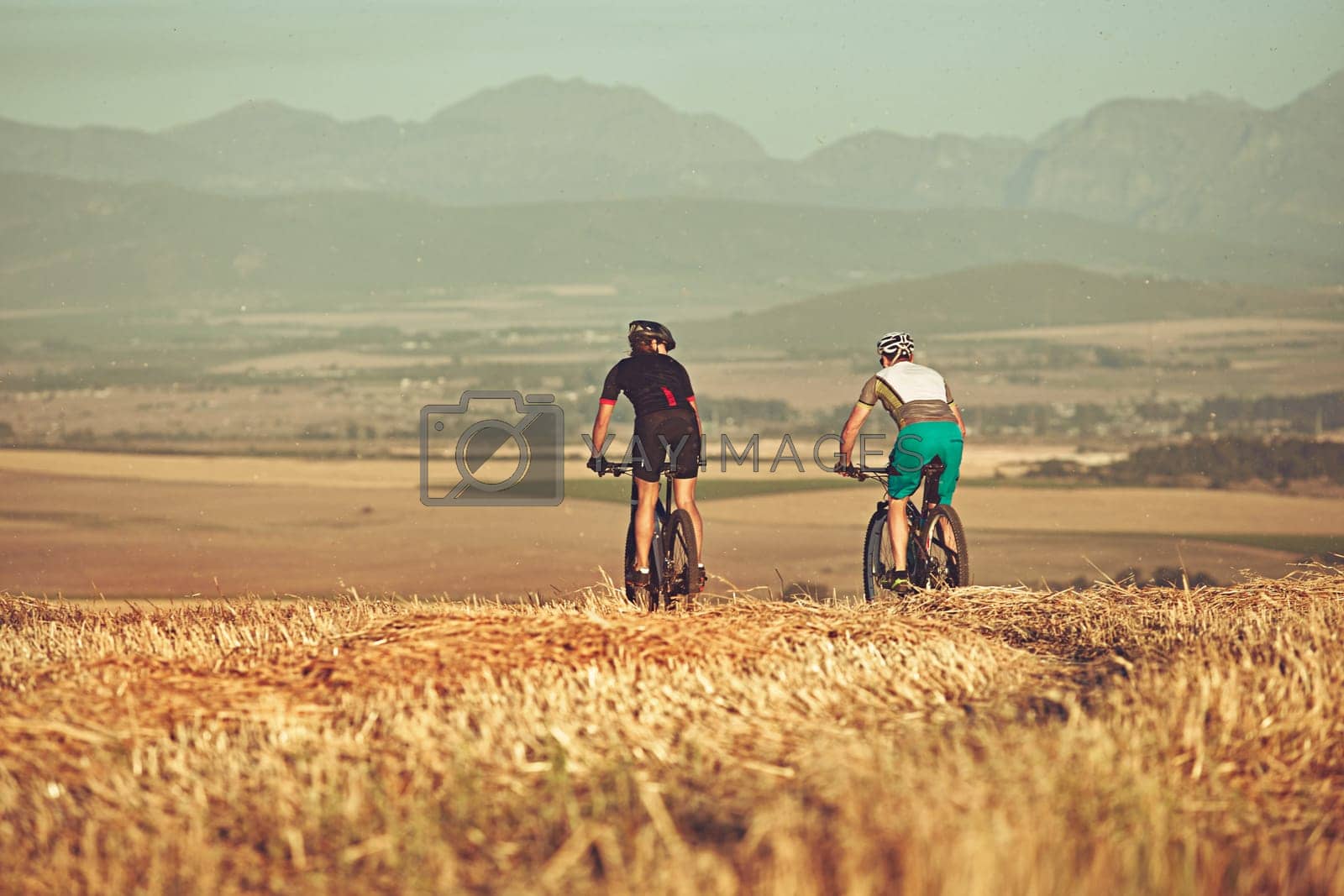 Royalty free image of Riding together till the end of time. two cyclists out cycling in the countryside. by YuriArcurs