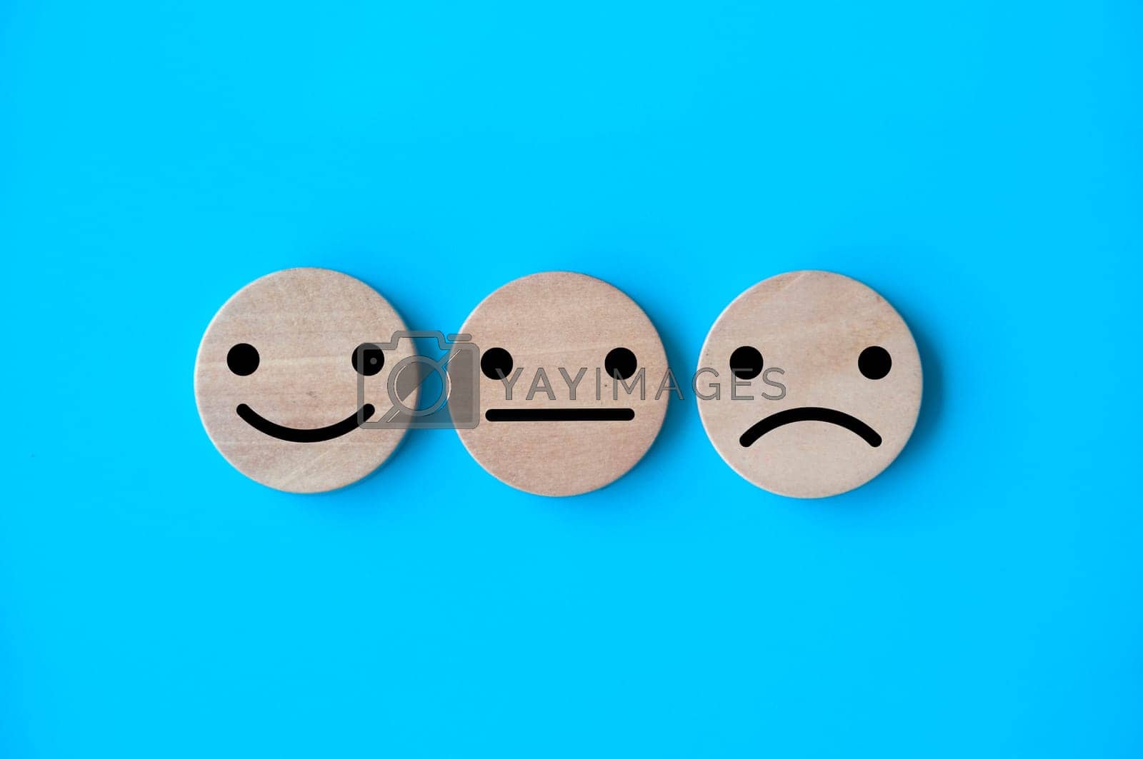 Royalty free image of Neutral, happy and sad emotion faces on wooden cubes. Customer satisfaction and evaluation concep by yom98
