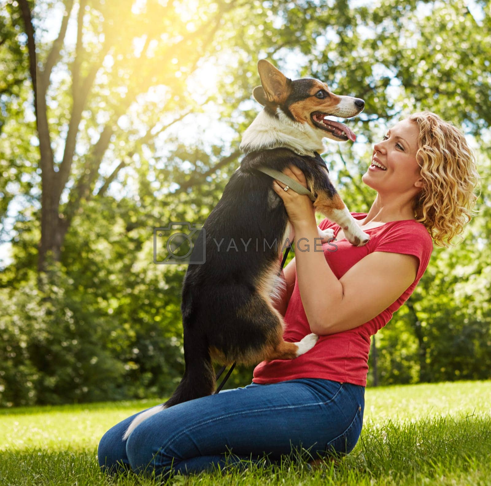 Royalty free image of Love your dog and hell love you back. a young woman bonding with her dog in the park. by YuriArcurs