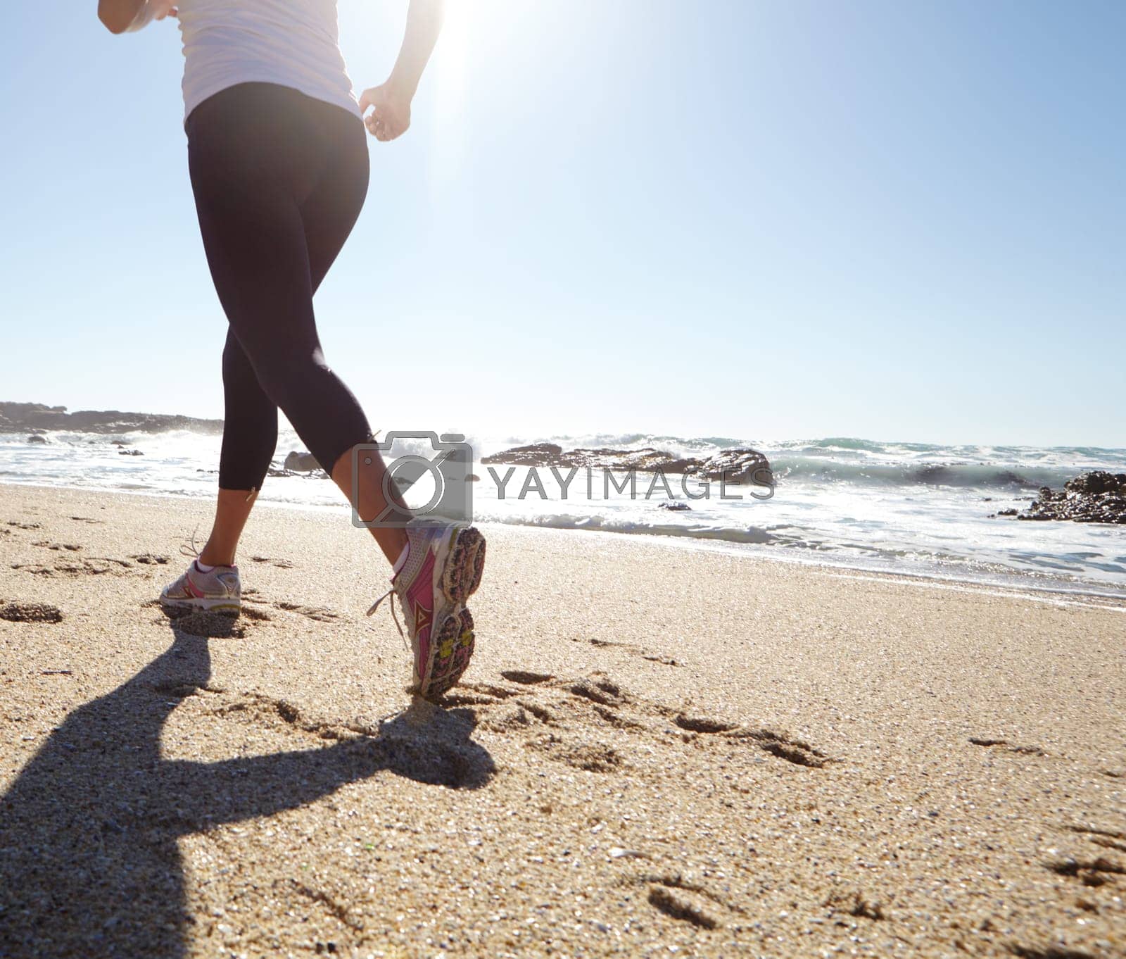 Royalty free image of Nature is her motivation. a young woman jogging on the beach. by YuriArcurs