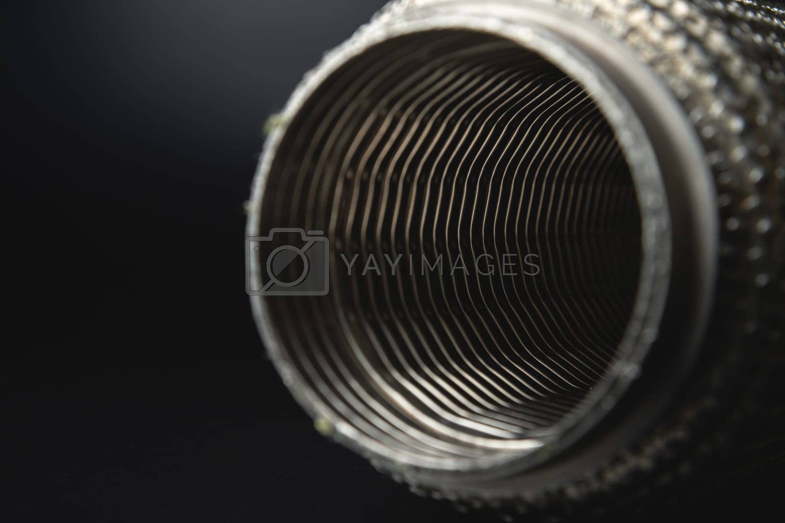 Royalty free image of Close-up Selective focus picture with noise effect of exhaust pipe flexible connector. by yanik88