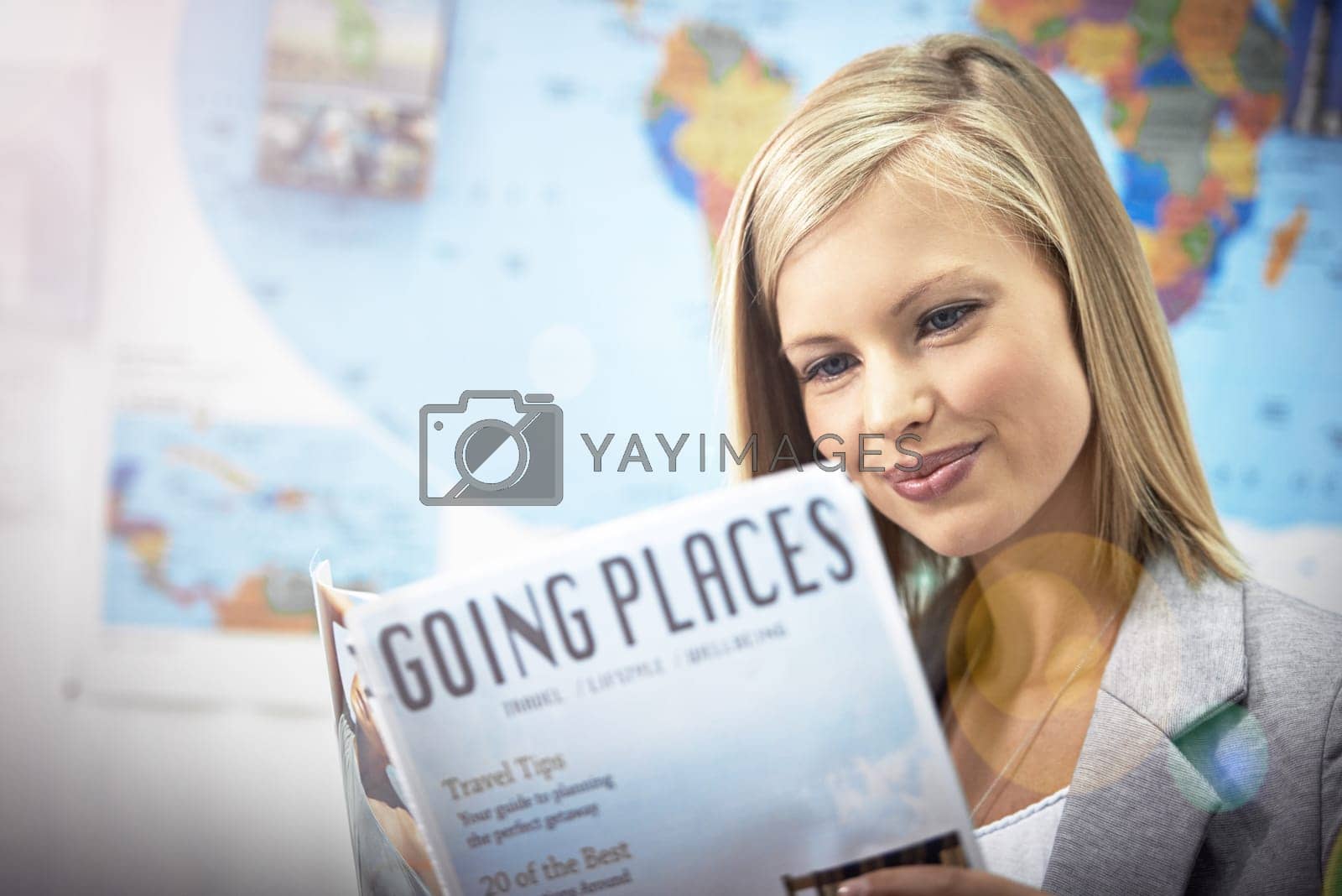 Royalty free image of Planning her next vacation. a young woman reading a travel magazine. by YuriArcurs