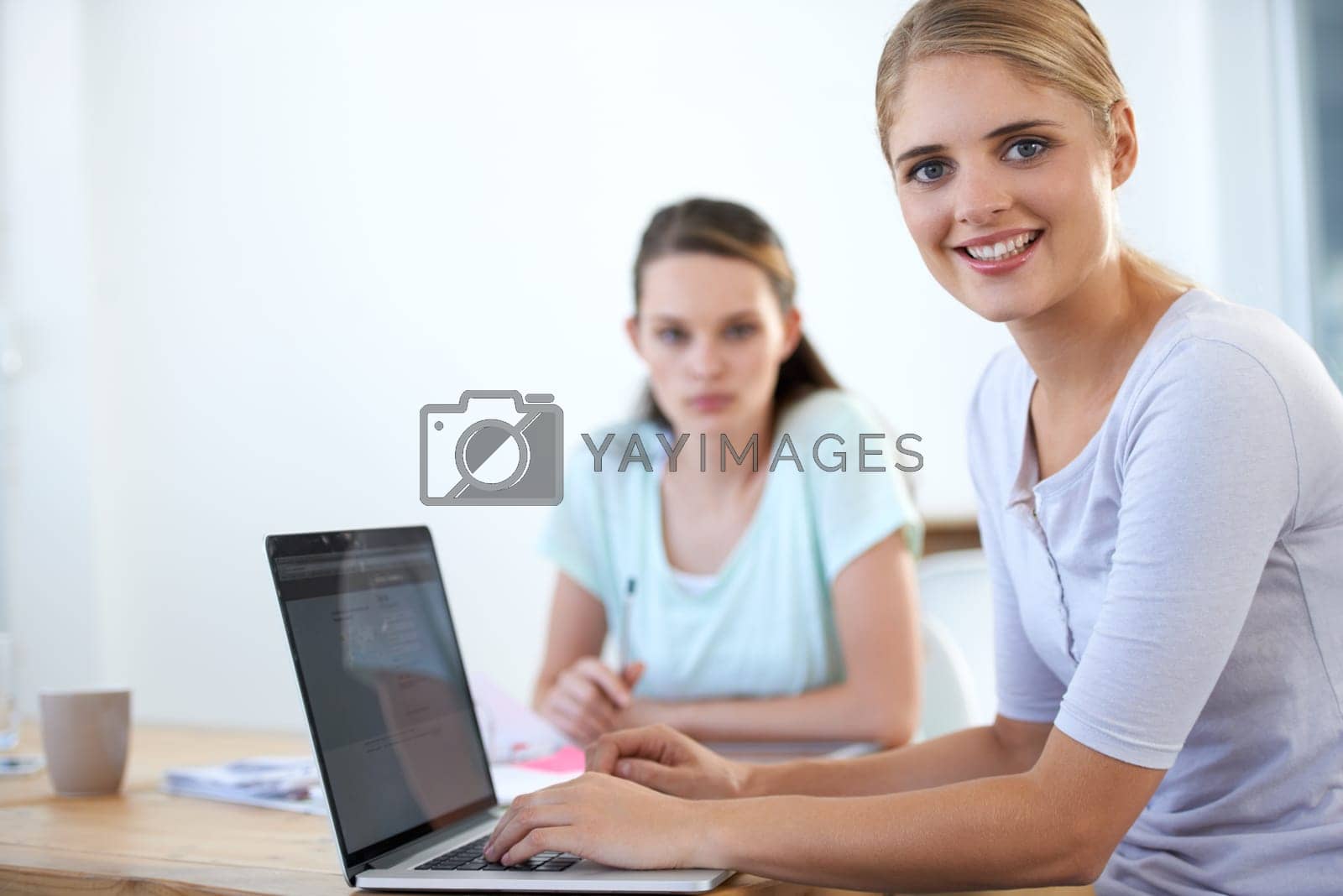 Royalty free image of Theyre the perfect pair. Two young colleagues working in the office. by YuriArcurs