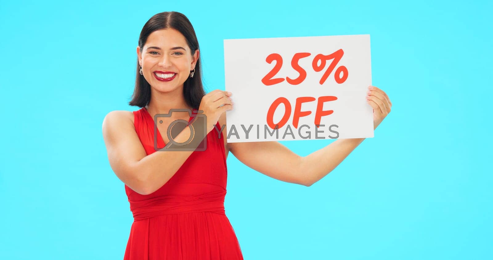 Royalty free image of Woman, portrait and sale sign for studio advertising percentage or discount rate on paper or banner. Smile of a happy female on a blue background for fashion promotion deal, savings or deal and offer by YuriArcurs